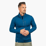Mann trägt Merino Jacke Herren 270 g/m², sportlich geschnitten, ideal für Outdoor-Abenteuer. Hochwertige Merinowolle sorgt für Komfort und Vielseitigkeit.