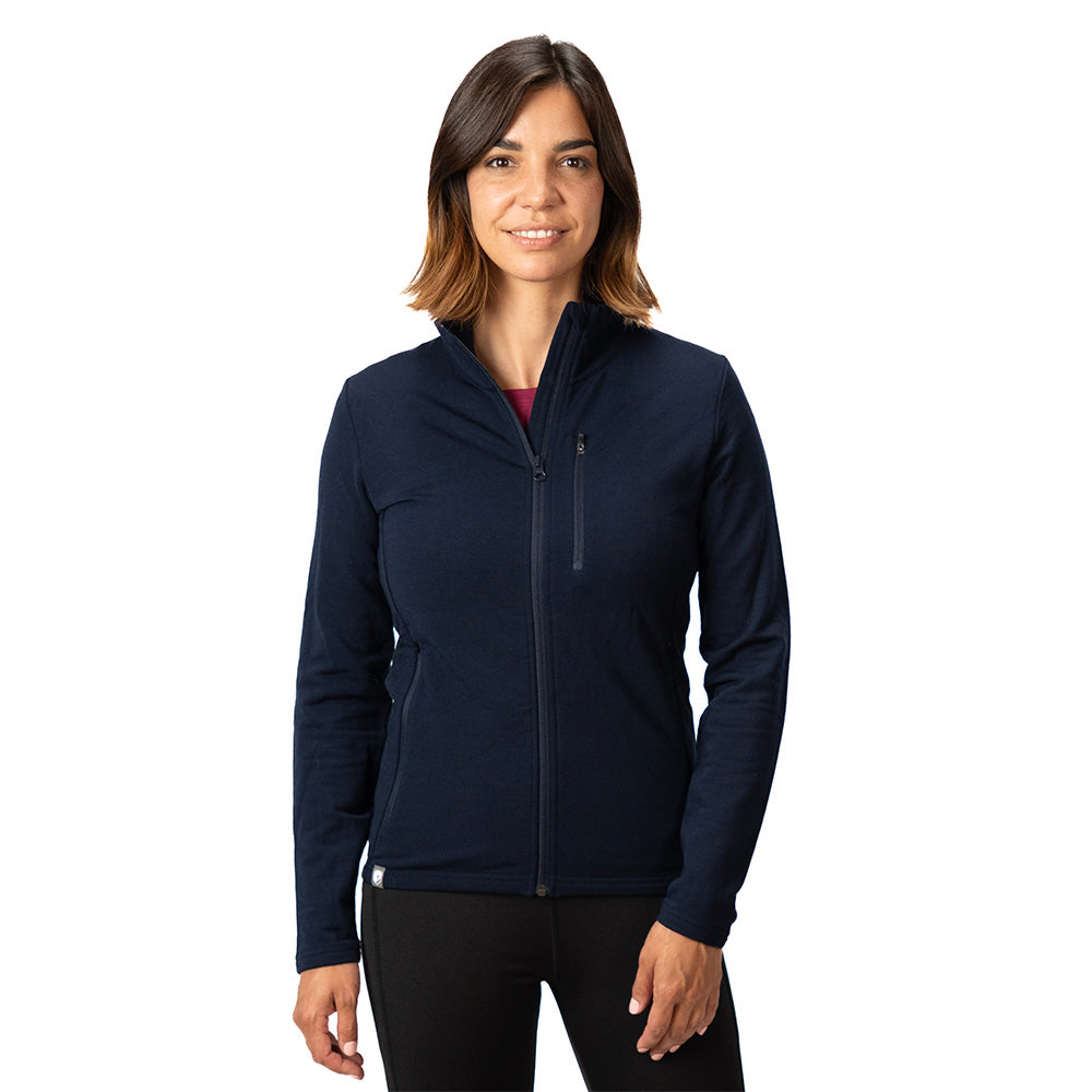 Frau trägt Merino Jacke Damen 270 g/m² aus Merinowolle, mit Reißverschlusstaschen, modisch und funktional, ideal für Outdoor-Aktivitäten.