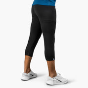 3/4 Merino lange Unterhose Herren 150 g/m2, getragen mit weißen Laufschuhen, ideal für Outdoor-Aktivitäten dank CORESPUN-Technologie und Temperaturregulierungseigenschaften.