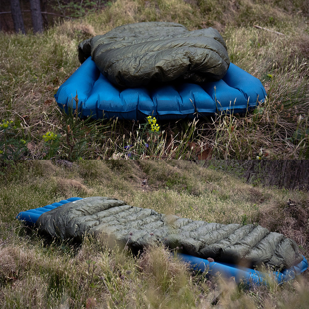 UL Down Quilt 450g auf blauem Luftmatratze auf Gras; ideal für ultraleichtes Camping mit hoher Wärmeisolierung und minimalem Gewicht.