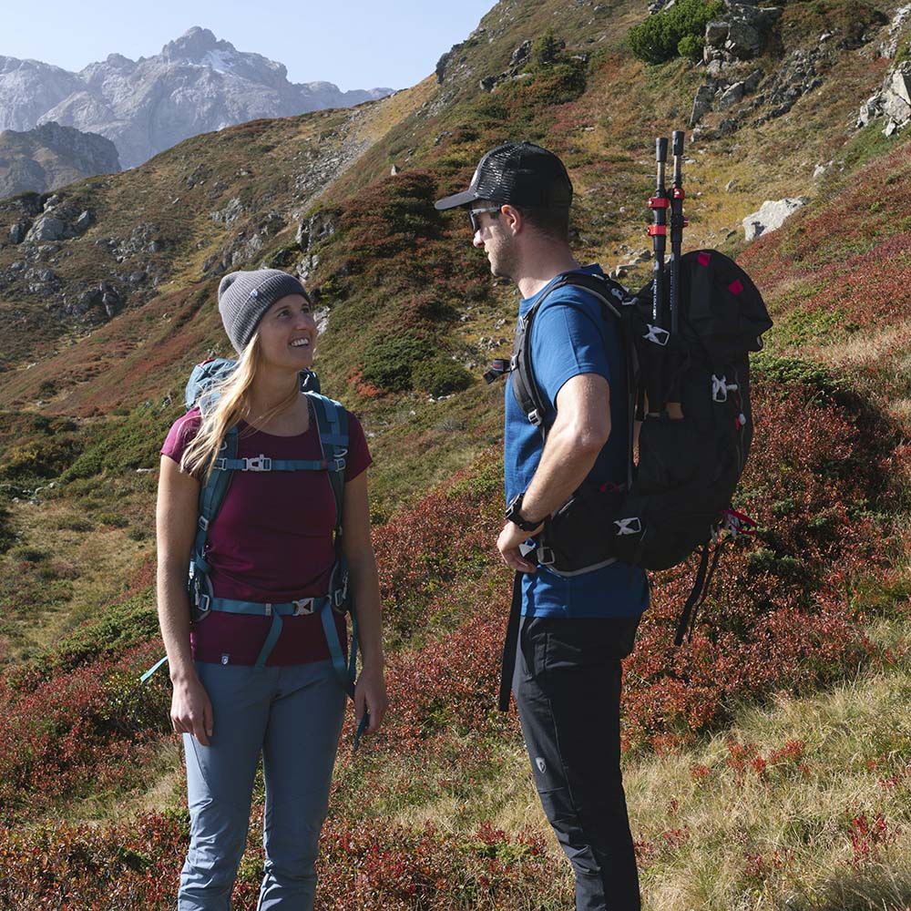 Zwei Wanderer auf Bergtour mit dem 35-Liter Wanderrucksack Herren & Damen von Alpin Loacker, ausgestattet mit Trekkingstöcken und funktionalem Design für Outdoor-Abenteuer.