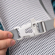Hände halten grauen Nylonriemen mit passender Kunststoffschnalle, Teil des 30 L Wanderrucksack Herren & Damen von Alpin Loacker, ideal für Outdoor-Abenteuer.