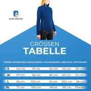 Frau trägt die Merino Jacke Damen 270 g/m², ideal für Outdoor-Abenteuer, vor einem Poster stehend, zeigt sportlichen Schnitt und erstklassige Funktionalität.